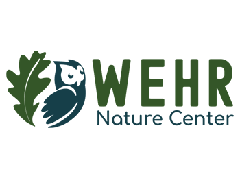 A green and blue logo of an oak leaf next to an owl. To the right of the images the word "WEHR" is displayed large above the words "Nature Center"